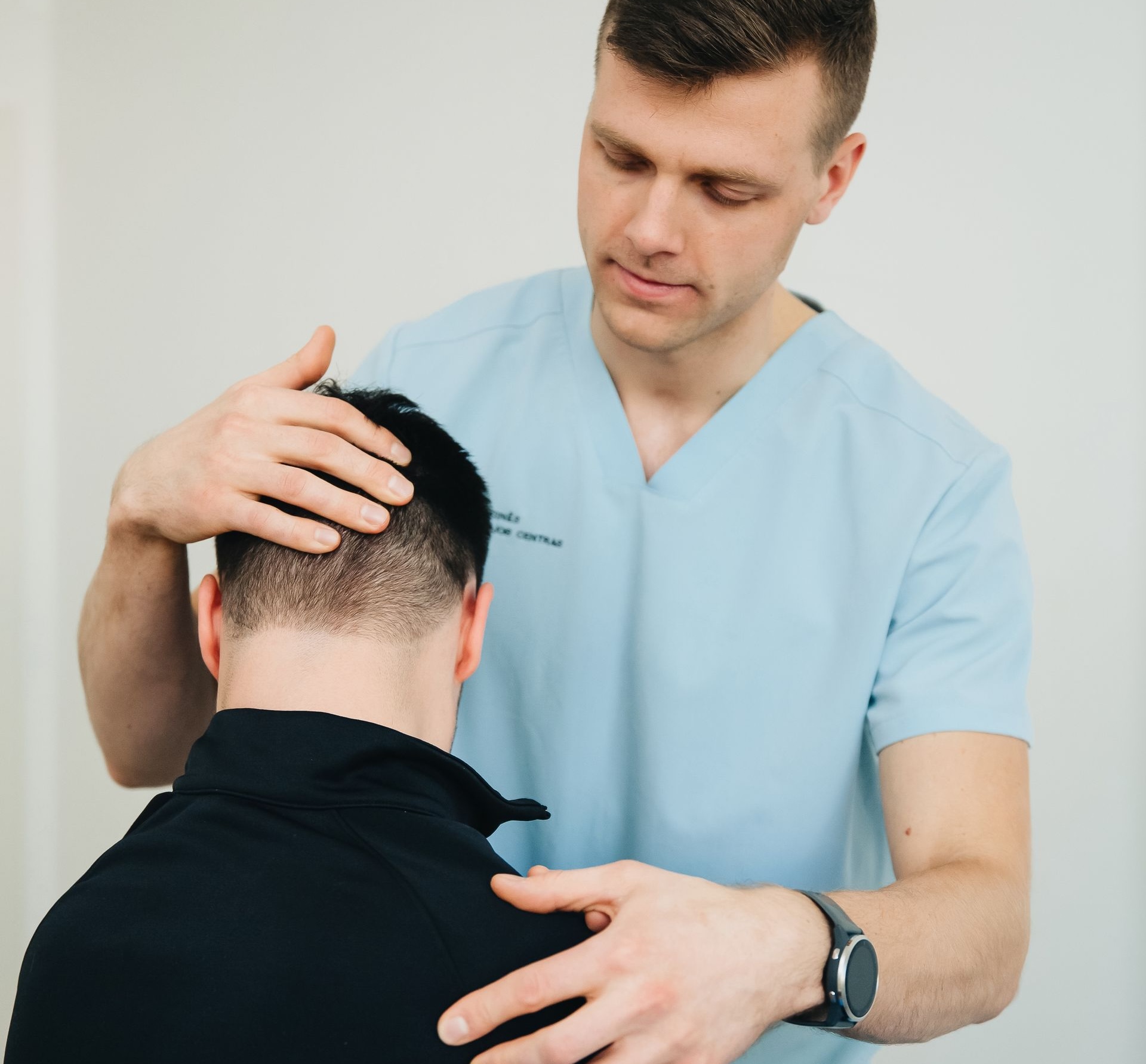 Clinician assessing the neck and symptoms related to cervical radiculopathy