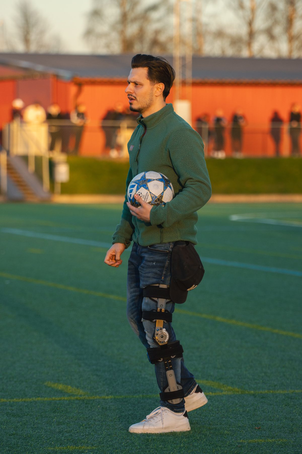 Man wearing a hinged knee brace outdoors.
