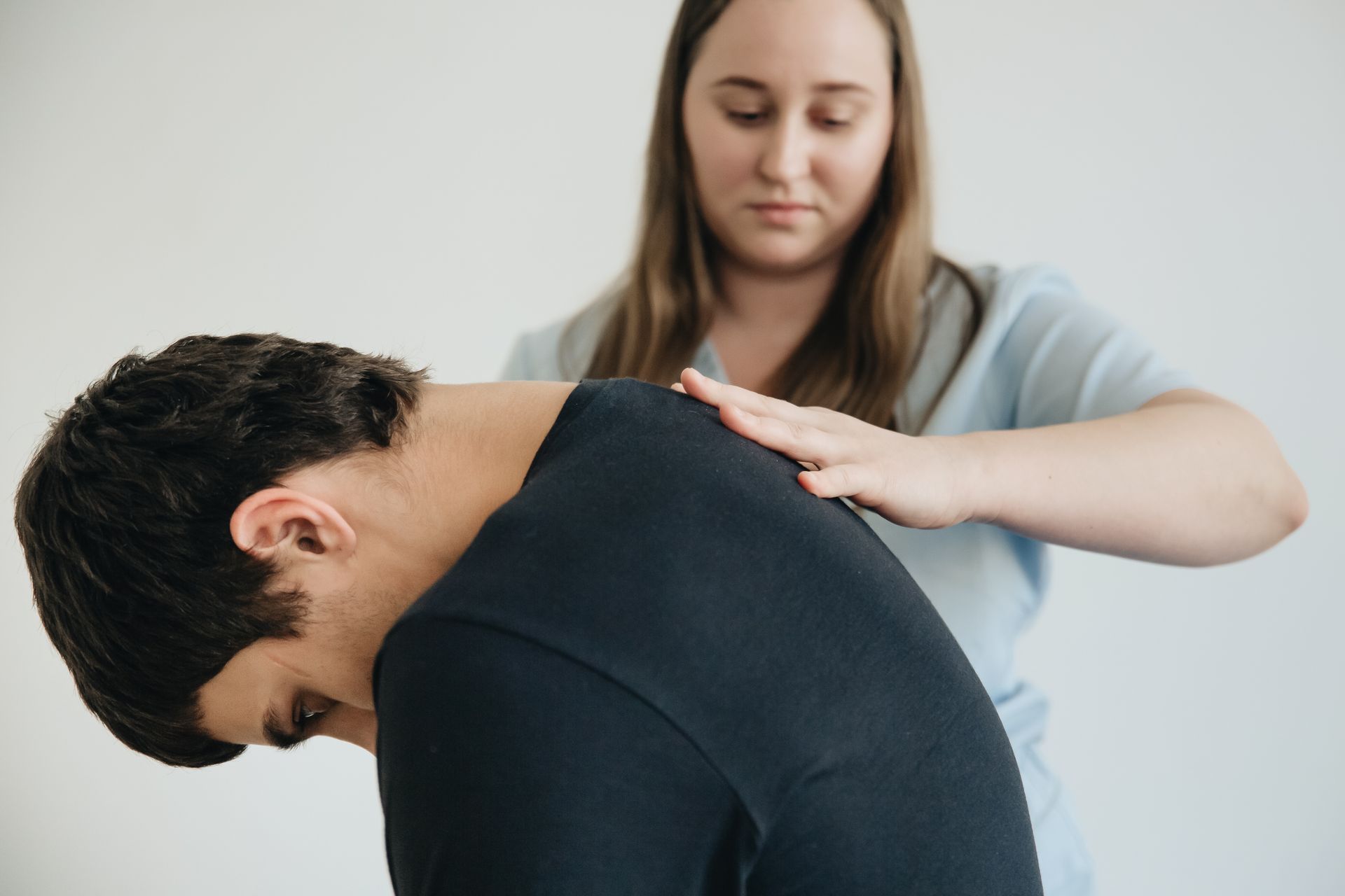 Healthcare professional assessing the leg and hip for pain